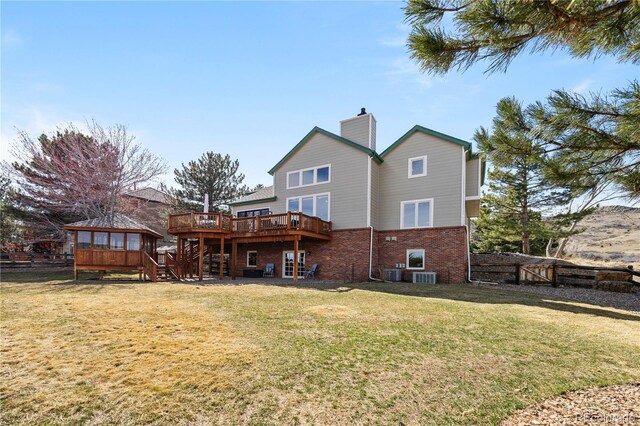 50 Deerwood Dr, Littleton, CO 80127 - back of property with stairway, a deck, brick siding, a chimney, and central air condition unit
