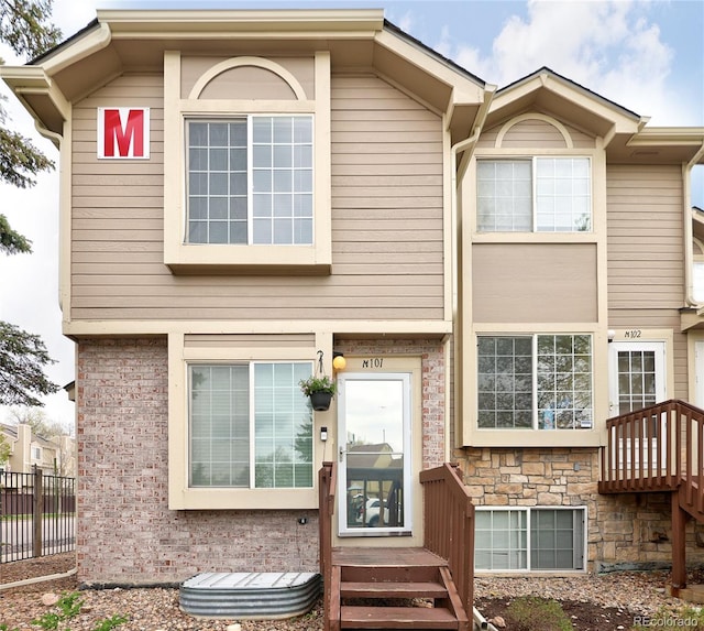 view of front of house featuring fence