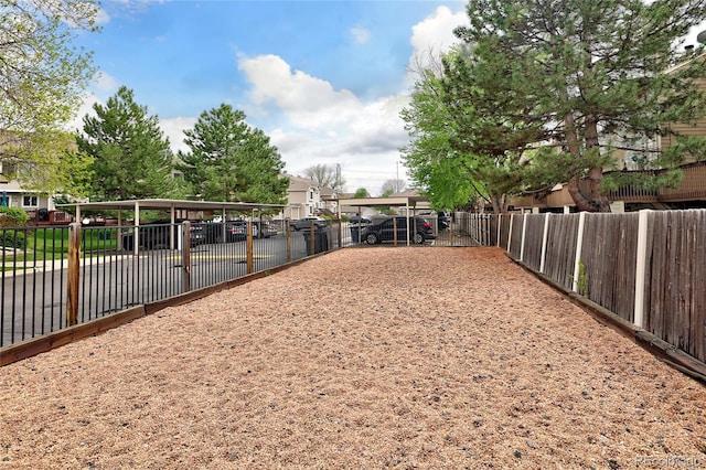 view of community featuring fence and a residential view