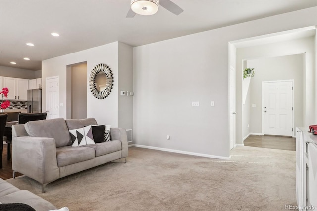 6491 N Danube St, Denver, CO 80249 - living room with light colored carpet, a ceiling fan, and recessed lighting