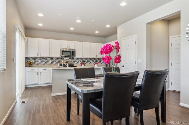 6491 N Danube St, Denver, CO 80249 - dining space with dark wood-style floors and recessed lighting