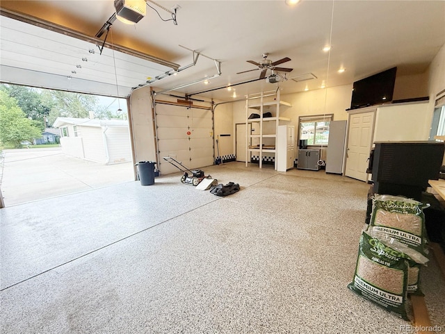 8930 W 55th Ave, Arvada, CO 80002 - garage featuring a garage door opener, freestanding refrigerator, recessed lighting, and a ceiling fan