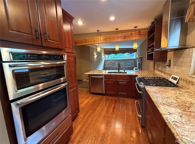 8930 W 55th Ave, Arvada, CO 80002 - kitchen with stainless steel appliances, wall chimney range hood, light wood-type flooring, backsplash, and recessed lighting