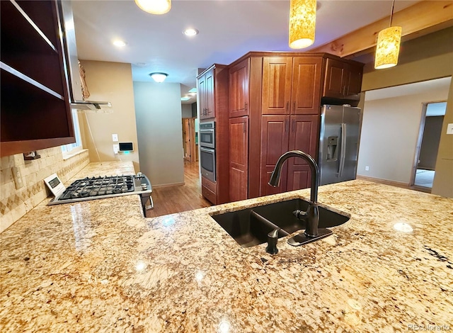 8930 W 55th Ave, Arvada, CO 80002 - kitchen featuring stainless steel appliances, light stone countertops, open shelves, and tasteful backsplash