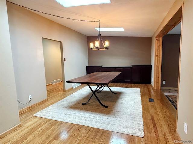 8930 W 55th Ave, Arvada, CO 80002 - unfurnished dining area with light wood finished floors and a chandelier