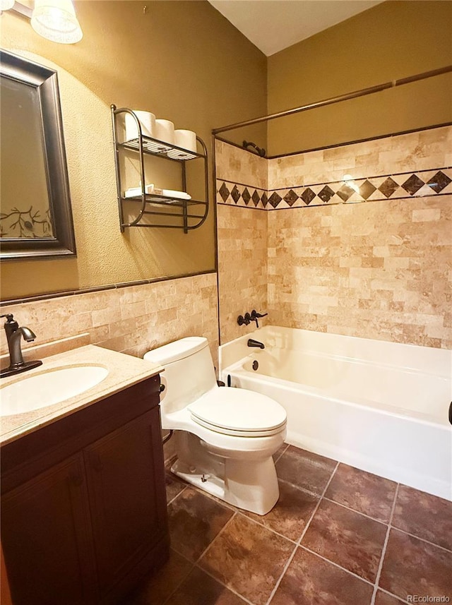 8930 W 55th Ave, Arvada, CO 80002 - bathroom featuring tile walls, vanity, tile patterned floors, and washtub / shower combination