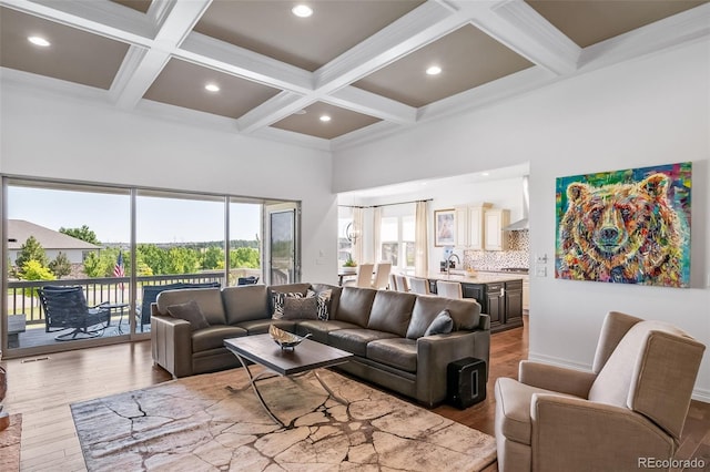 23615 E Del Norte Pl, Aurora, CO 80016 - living room with coffered ceiling, healthy amount of natural light, wood finished floors, a high ceiling, and beam ceiling