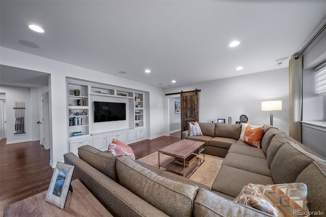 23615 E Del Norte Pl, Aurora, CO 80016 - living room featuring a barn door, wood finished floors, recessed lighting, and built in features