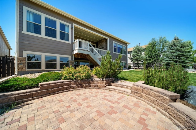23615 E Del Norte Pl, Aurora, CO 80016 - rear view of house featuring a patio, stairway, and stone siding