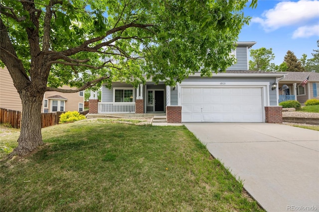 18121 E Adriatic, Aurora, CO 80013 - view of property hidden behind natural elements with concrete driveway, brick siding, covered porch, and a garage
