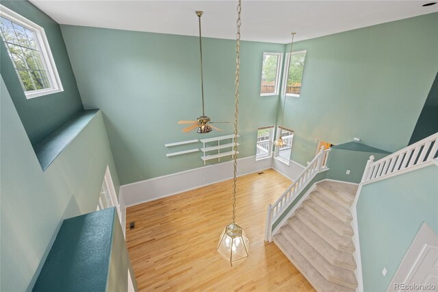 18121 E Adriatic, Aurora, CO 80013 - stairway with healthy amount of natural light, wood finished floors, and baseboards