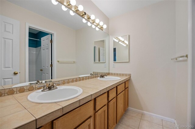 18121 E Adriatic, Aurora, CO 80013 - full bathroom with double vanity, tile patterned floors, and baseboards