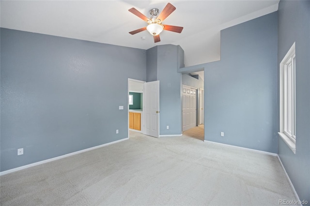 18121 E Adriatic, Aurora, CO 80013 - unfurnished bedroom with vaulted ceiling, carpet, baseboards, a ceiling fan, and multiple windows