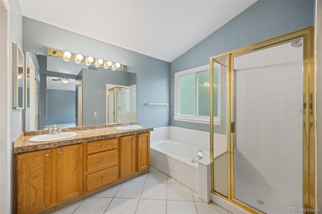 18121 E Adriatic, Aurora, CO 80013 - bathroom with vaulted ceiling, a stall shower, a bath, double vanity, and tile patterned flooring