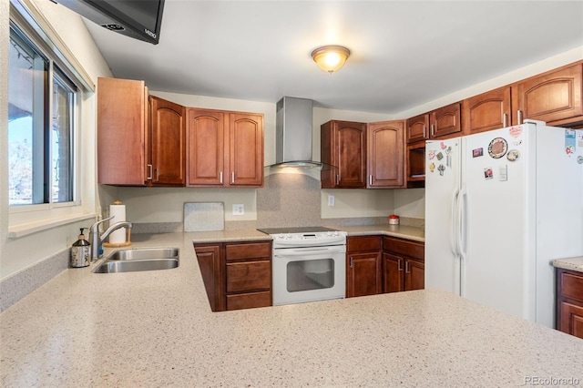 kitchen featuring wall chimney range hood, white appliances, and sink