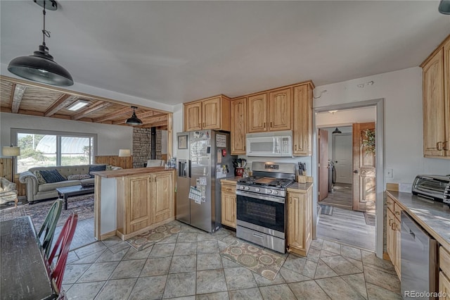 kitchen with beamed ceiling, appliances with stainless steel finishes, light hardwood / wood-style flooring, and light brown cabinets