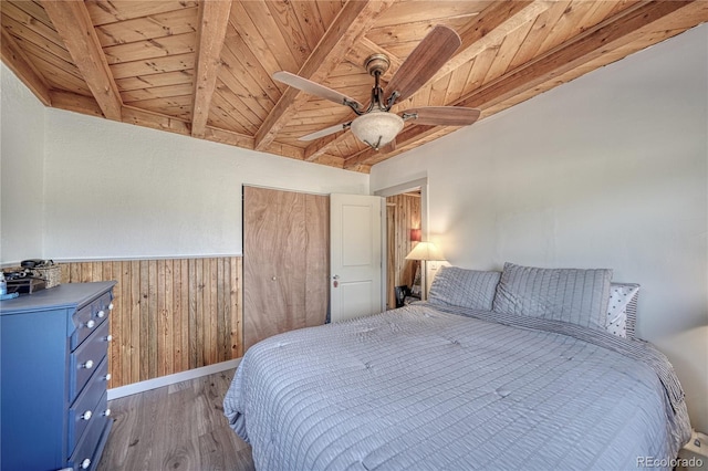 bedroom featuring wood ceiling, beam ceiling, ceiling fan, and hardwood / wood-style flooring