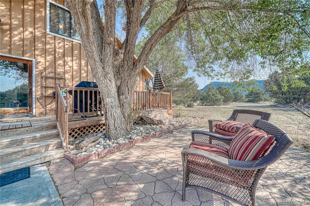 view of patio / terrace featuring a deck with mountain view