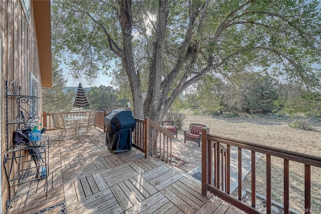 wooden deck featuring a grill