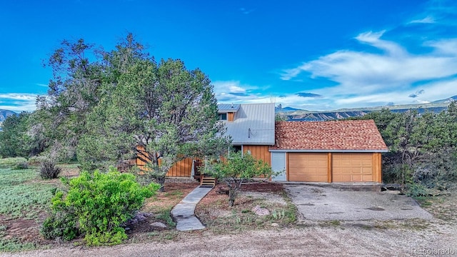 view of front of property with a garage and a mountain view