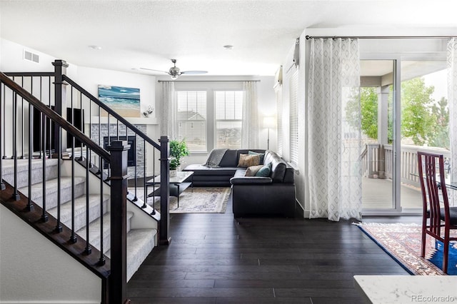 500 176th Ave, Broomfield, CO 80023 - living area featuring dark wood-style flooring, ceiling fan, visible vents, and stairway