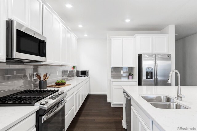 500 176th Ave, Broomfield, CO 80023 - kitchen with a sink, stainless steel appliances, recessed lighting, decorative backsplash, and dark wood-style floors