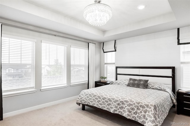 500 176th Ave, Broomfield, CO 80023 - carpeted bedroom with baseboards, a raised ceiling, and a chandelier