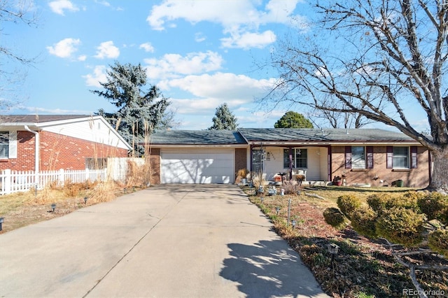 ranch-style house with brick siding, covered porch, fence, a garage, and driveway