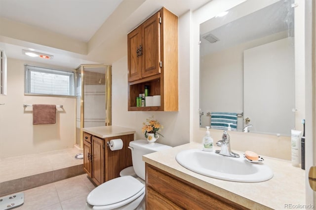 full bath with toilet, a stall shower, tile patterned flooring, and vanity