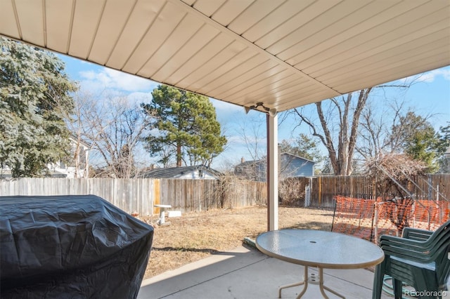 view of patio with a fenced backyard and a grill