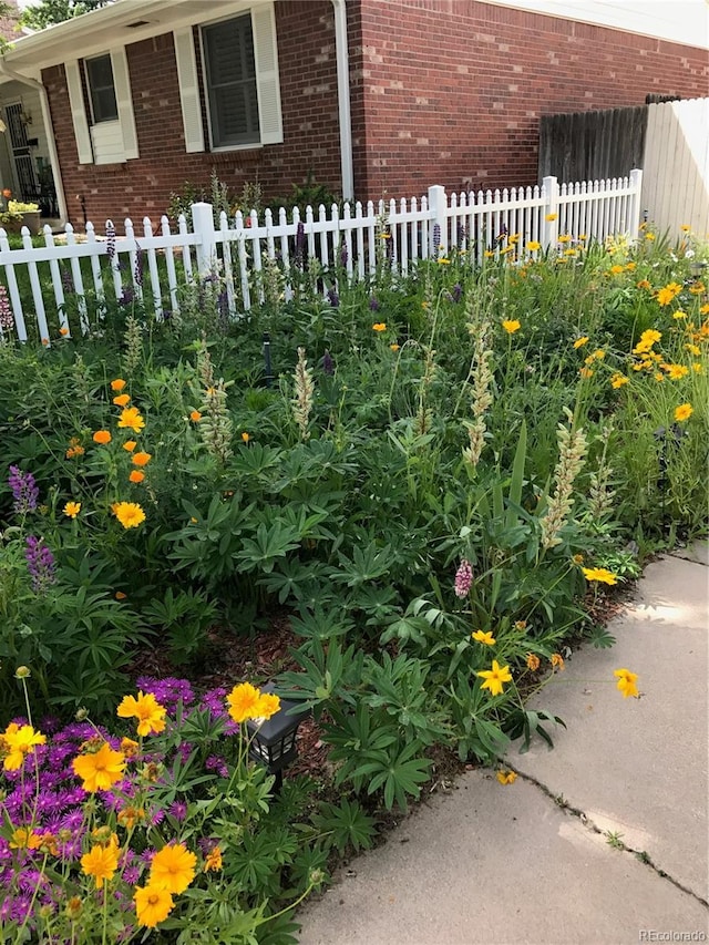 exterior space with brick siding and fence