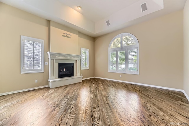 85 Silver Fox Dr, Greenwood Village, CO 80121 - unfurnished living room featuring wood finished floors, a glass covered fireplace, and baseboards