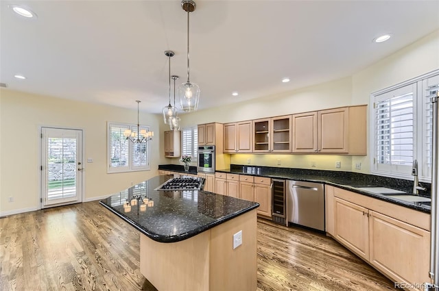 85 Silver Fox Dr, Greenwood Village, CO 80121 - kitchen with appliances with stainless steel finishes, light brown cabinetry, wine cooler, a chandelier, and light wood-type flooring