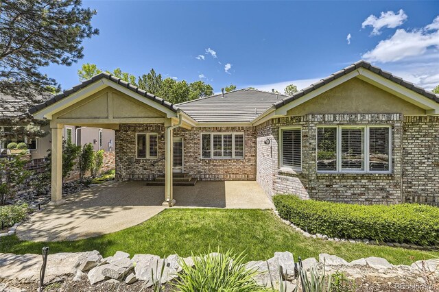 85 Silver Fox Dr, Greenwood Village, CO 80121 - rear view of property with a patio area, stucco siding, a tile roof, and brick siding