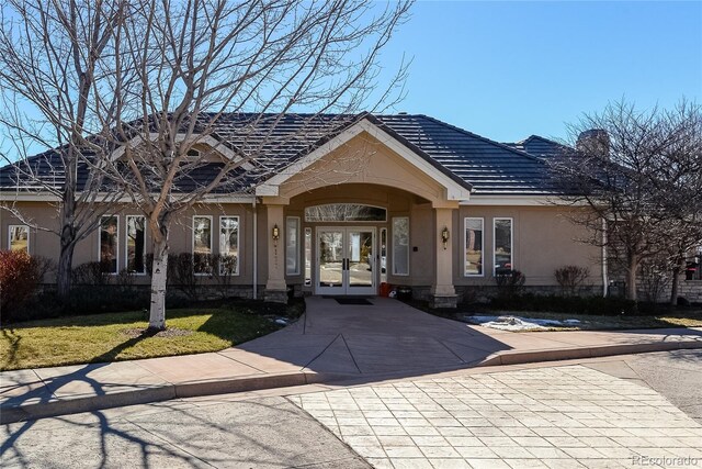 85 Silver Fox Dr, Greenwood Village, CO 80121 - property entrance featuring french doors, stucco siding, a lawn, and a chimney