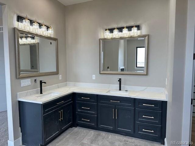 full bathroom with a sink and double vanity