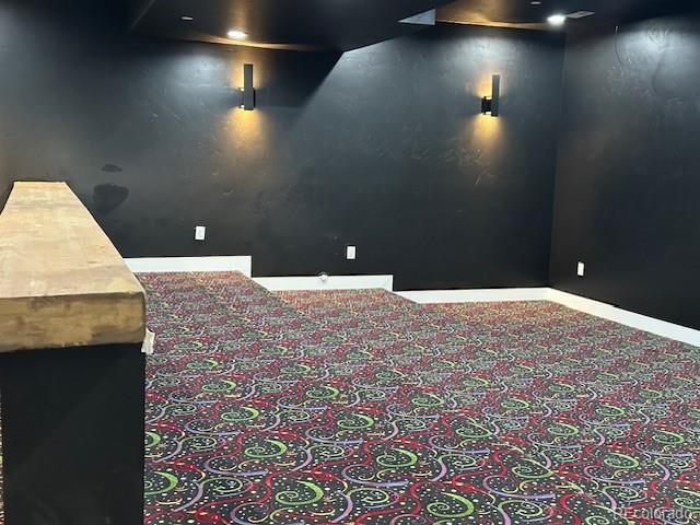 carpeted cinema with baseboards