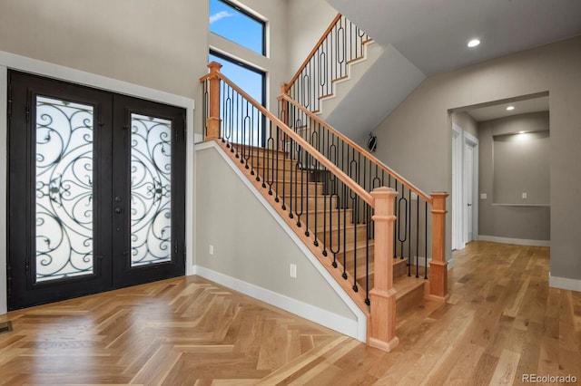 foyer entrance featuring visible vents, baseboards, recessed lighting, french doors, and a towering ceiling