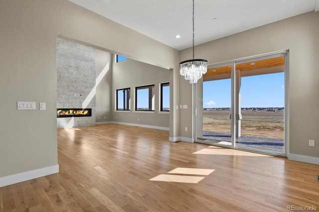 16250 Kenosha St, Brighton, CO 80603 - interior space with a glass covered fireplace, baseboards, and wood finished floors