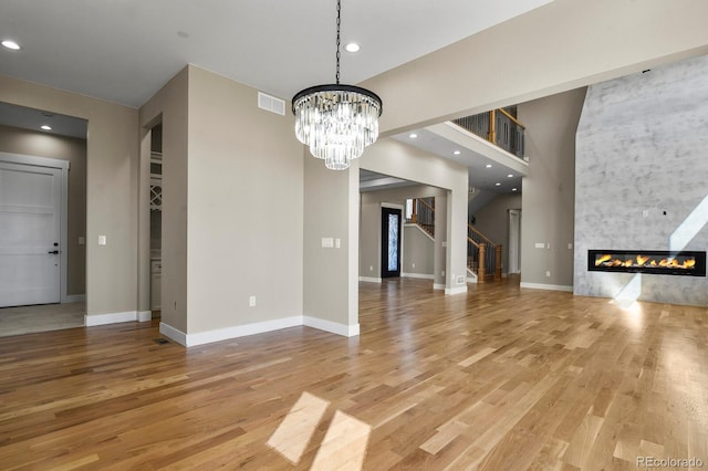 16250 Kenosha St, Brighton, CO 80603 - interior space with stairs, visible vents, light wood-style flooring, and a fireplace