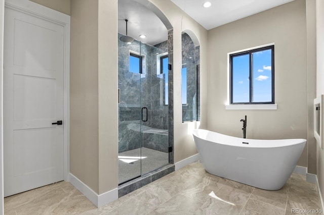 16250 Kenosha St, Brighton, CO 80603 - full bathroom with a shower stall, baseboards, marble finish floor, and a freestanding bath