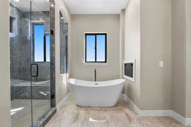 16250 Kenosha St, Brighton, CO 80603 - full bath featuring a shower stall, a freestanding tub, baseboards, and marble finish floor