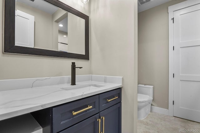 16250 Kenosha St, Brighton, CO 80603 - bathroom with vanity, toilet, visible vents, and baseboards