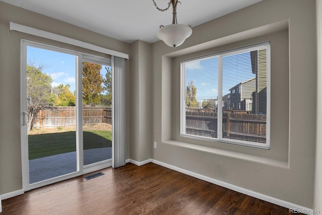 unfurnished dining area with dark hardwood / wood-style floors