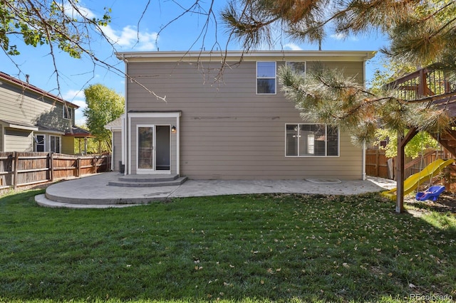 rear view of house featuring a patio and a yard