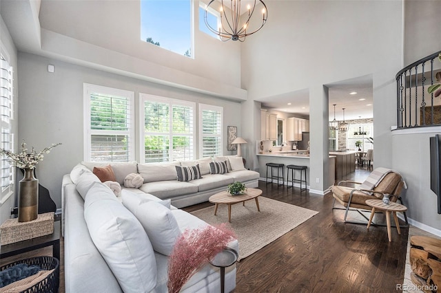 8548 Winter Berry Dr, Castle Pines, CO 80108 - living room with a chandelier, dark wood finished floors, plenty of natural light, and a towering ceiling