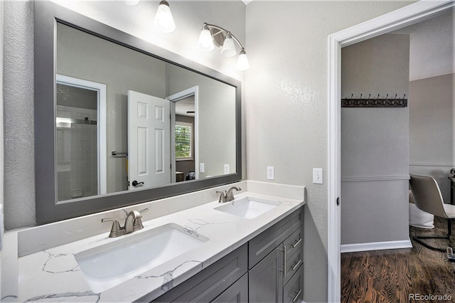 8548 Winter Berry Dr, Castle Pines, CO 80108 - bathroom with wood finished floors, a shower, double vanity, and a textured wall