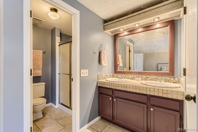 14193 E Radcliff Cir, Aurora, CO 80015 - bathroom with toilet, tile patterned floors, a stall shower, and double vanity