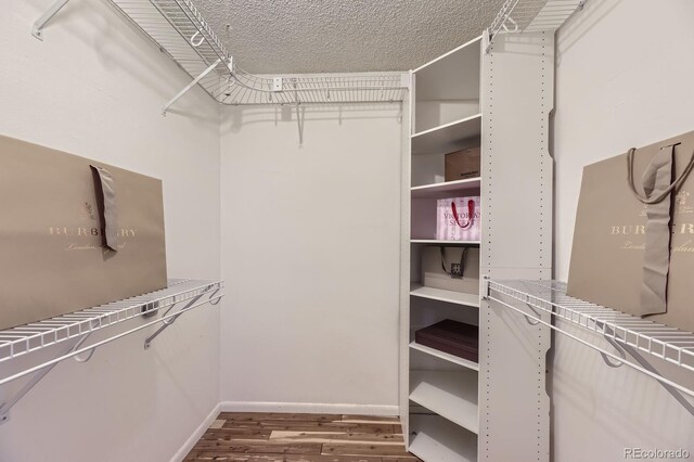 14193 E Radcliff Cir, Aurora, CO 80015 - walk in closet featuring wood finished floors