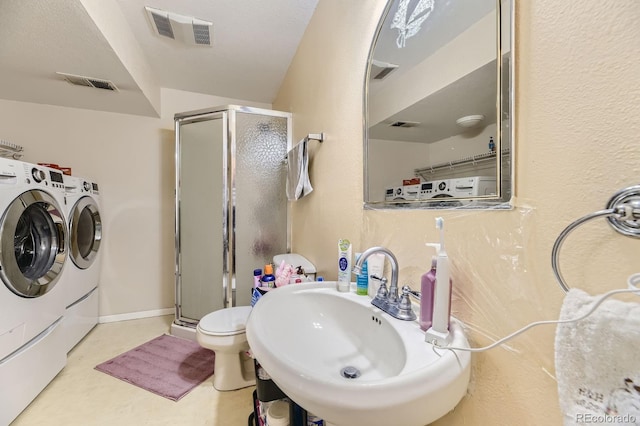 14193 E Radcliff Cir, Aurora, CO 80015 - bathroom with separate washer and dryer, a sink, a stall shower, and toilet